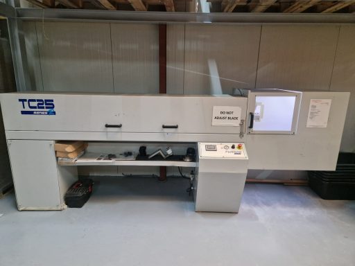 Parkland TC25 A large, industrial machine with control panel and viewing window, set in a workshop.